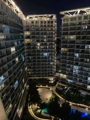 a view of two tall buildings at night at Azure Residences Getaway in Manila