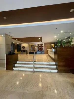 a lobby with a staircase in a building at A Venue Residences 2403 in Makati