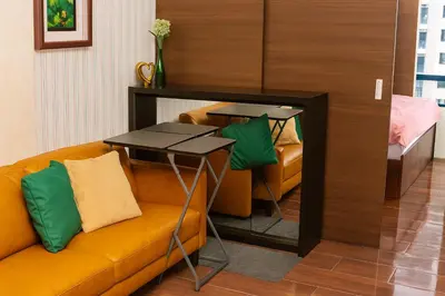 a living room with a couch and a table at Serene Stay Air Makati Boutique Comfort City Perks 1767 in Manila
