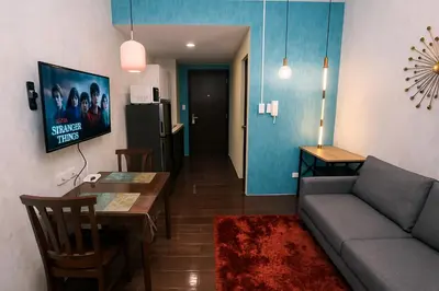a living room with a couch and a table at The Plush Pad Makati Ayala Views 300MB WiFi 1940 in Manila