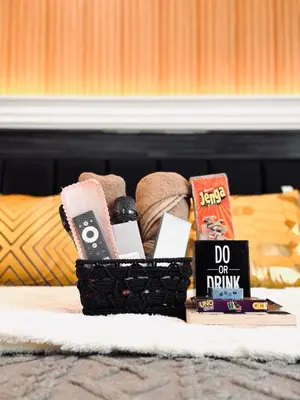 a basket of books and other items on a bed at Azure Urban Resort paranaque in Manila