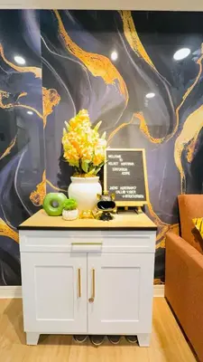 a table with a vase of flowers and fruit on it at Azure Urban Resort paranaque in Manila