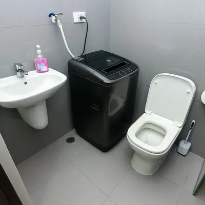 a bathroom with a trash can next to a toilet and a sink at Suite Life Makati Vibes Views Relaxation 3870 in Manila
