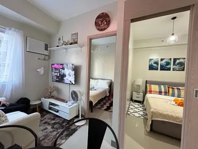 a room with a mirror and a bedroom with a bed at The Minimal Getaway in Manila