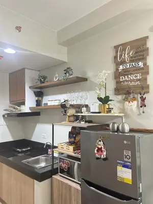 a kitchen with a refrigerator and a sink at The Minimal Getaway in Manila