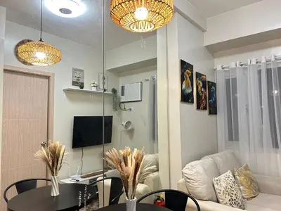 a living room with a table and a couch at The Minimal Getaway in Manila