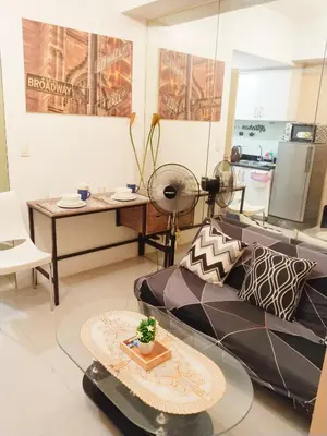 a living room with a couch and a table at Maria's staycation in Manila