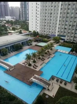 an overhead view of a large swimming pool in a city at Maria's staycation in Manila