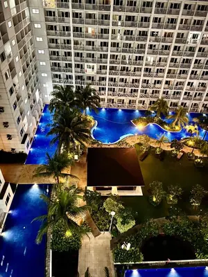 an overhead view of a large building with palm trees at Apartments at Shore 1 Residences MOA Pasay Near Airport in Manila