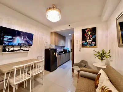 a living room with a couch and a table at Apartments at Shore 1 Residences MOA Pasay Near Airport in Manila