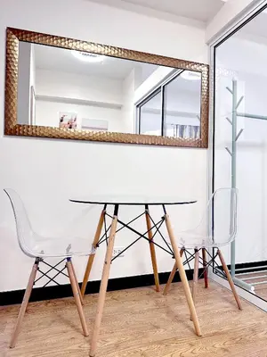 a table and two chairs in front of a mirror at Skyline Hideout in Sampong