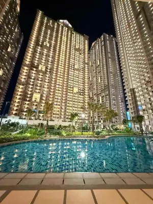 a swimming pool in front of two tall buildings at Skyline Hideout in Sampong