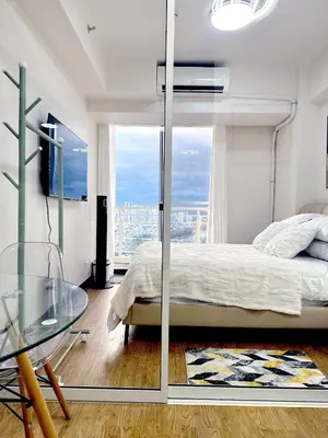 a bedroom with a bed and a glass table at Skyline Hideout in Sampong