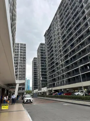 a car parked in front of a large building at Cozy Condo Near MOA & Airport in Manila