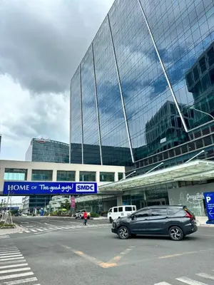 a car parked in a parking lot in front of a building at Cozy Condo Near MOA & Airport in Manila