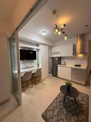 a large kitchen with a table and a dining room at Azure Residences Penthouse in Manila