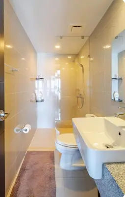 a white bathroom with a toilet and a sink at Mystay25V-ParksuitesTower1 in Manila
