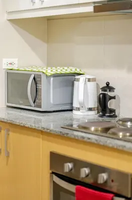 a microwave sitting on a counter in a kitchen at Mystay25V-ParksuitesTower1 in Manila