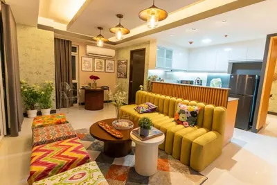 a living room with a couch and a table at Premium 1BR suite Modern Filipino at BGC w balcony in Manila