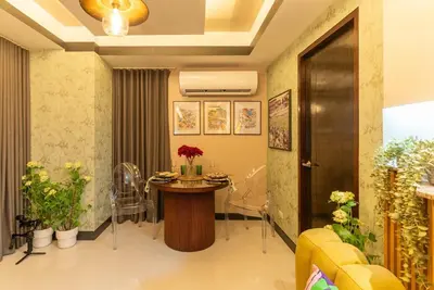 a living room with a table and chairs at Premium 1BR suite Modern Filipino at BGC w balcony in Manila