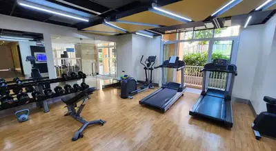 a gym with treadmills and cardio equipment in a room at Premium 1BR suite Modern Filipino at BGC w balcony in Manila