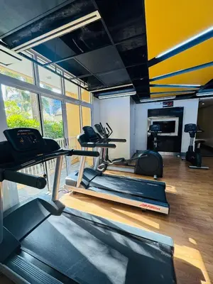 a gym with two treadmills and a treadmill at Premium 1BR suite Modern Filipino at BGC w balcony in Manila