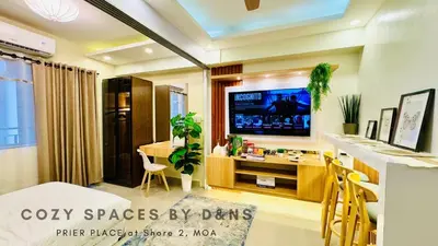 a living room with a tv and a dining room at MOA Newly Turn Over 1 bedroom with balcony PRIER Place in Manila