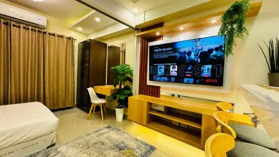 a living room with a large flat screen tv on the wall at MOA Newly Turn Over 1 bedroom with balcony PRIER Place in Manila