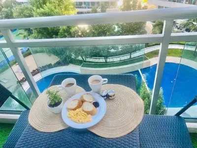 a plate of breakfast food on a table on a balcony at Dream Catcher Theme Unit in Manila