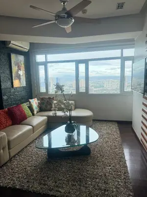 a living room with a couch and a table at 4 Bedroom Luxury Condo in Ortigas in Manila