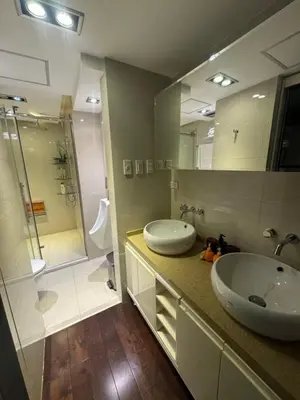 a bathroom with two sinks and a large mirror at 4 Bedroom Luxury Condo in Ortigas in Manila
