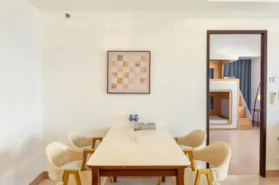 a dining room with a table and chairs at Premium 2 Bedroom and 1 Living Room Suite with Balcony - One Uptown, BGC in Manila