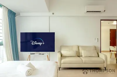 a hotel room with a bed and a couch at Premium 2 Bedroom and 1 Living Room Suite with Balcony - One Uptown, BGC in Manila