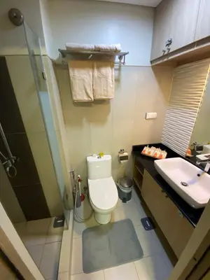 a bathroom with a toilet and a sink at Casa Orana in Manila
