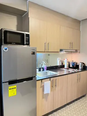 a kitchen with a stainless steel refrigerator and a sink at Casa Orana in Manila