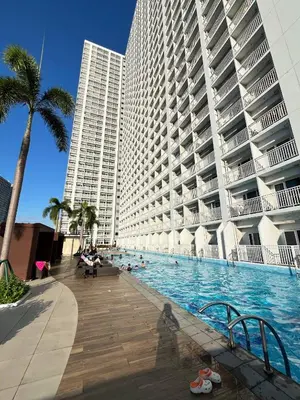 a swimming pool in front of a large building at Casa Orana in Manila