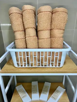 a shelf with a basket full of rolls of towels at Casa JYD at Shore Residences - Mall of Asia in Manila