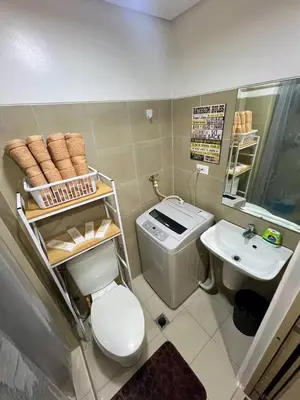 a small bathroom with a toilet and a sink at Casa JYD at Shore Residences - Mall of Asia in Manila