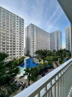 a view of a resort with a pool and buildings at Casa JYD at Shore Residences - Mall of Asia in Manila