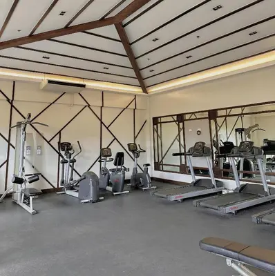 a gym with several treadmills and exercise machines at The Intramuros Suite in Manila