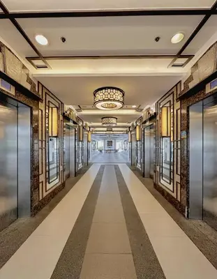 an empty hallway in a building with a chandelier at The Intramuros Suite in Manila