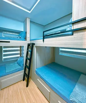 a room with two bunk beds and a ladder at The Intramuros Family Suite in Manila