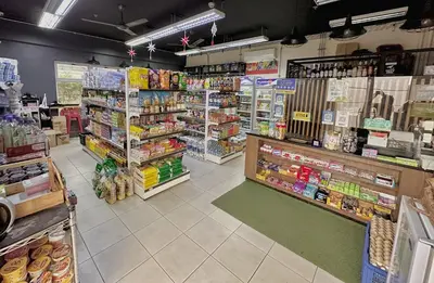 a store aisle of a grocery store with a lot of products at The Intramuros Family Suite in Manila