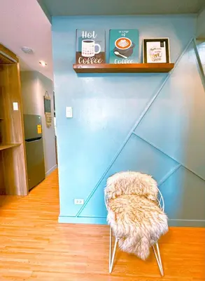 a chair in a room with a blue wall at The Intramuros Family Suite in Manila