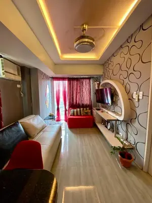 a living room with a couch and a tv at Casa Maria in Manila