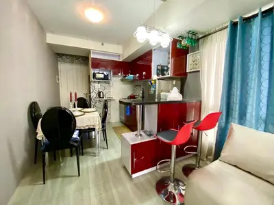 a room with red cabinets and a table and chairs at Casa Maria in Manila