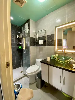 a bathroom with a toilet and a sink and a shower at Casa Maria in Manila