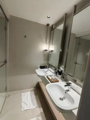 a bathroom with two sinks and a mirror at Acqua Private Residences in Manila
