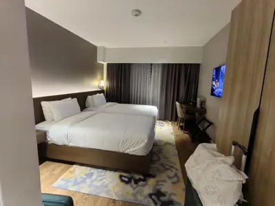 a hotel room with a bed and a desk at Acqua Private Residences in Manila