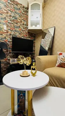 a living room with a white table and a fireplace at Dawn Haven Staycation in Manila